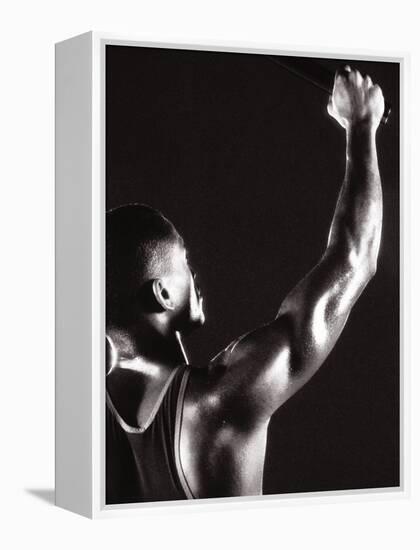 Male Runner Holding Up a Relay Baton-null-Framed Premier Image Canvas