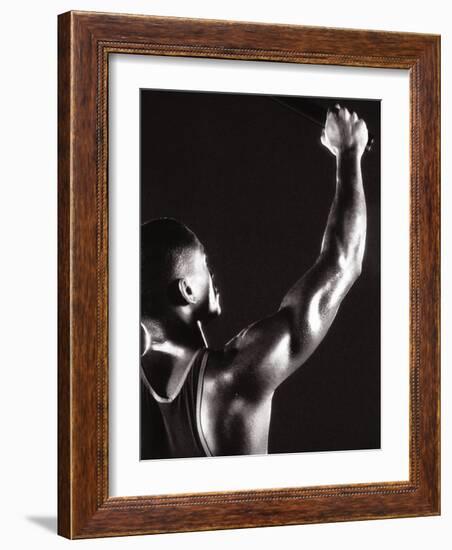 Male Runner Holding Up a Relay Baton-null-Framed Photographic Print