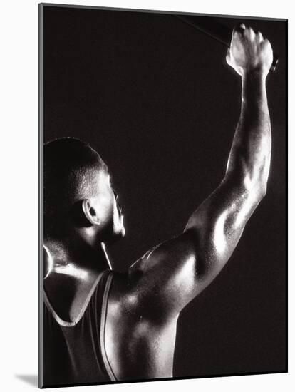 Male Runner Holding Up a Relay Baton-null-Mounted Photographic Print