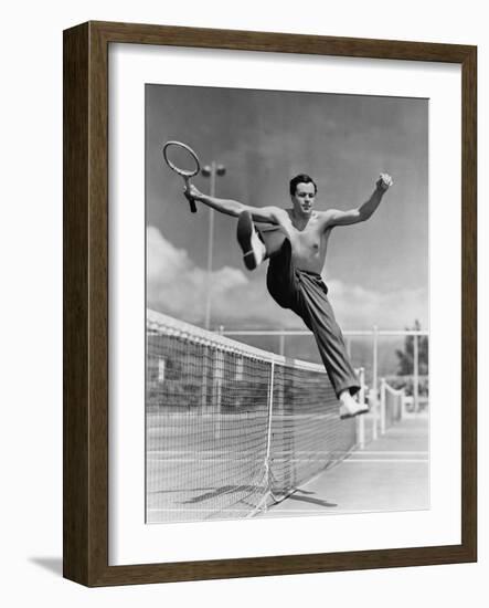 Male Tennis Player Jumping over Net-null-Framed Photo