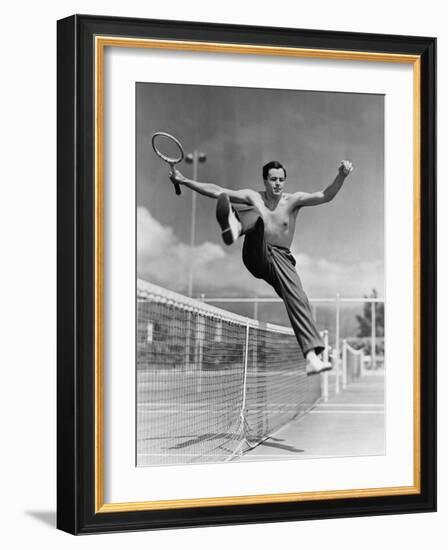 Male Tennis Player Jumping over Net-null-Framed Photo