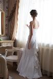 Beautiful Bride in White Wedding Dress Standing in Her Bedroom and Looking in Window-Malyugin-Photographic Print