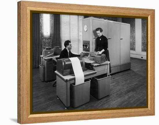 Man and a Women Working Together with a Pegasus Computer-null-Framed Premier Image Canvas