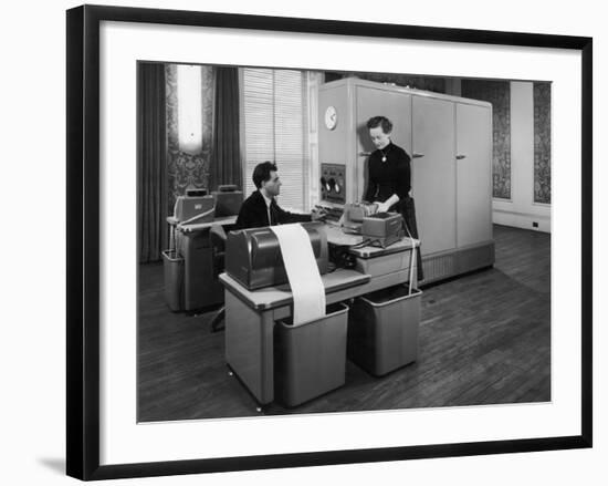 Man and a Women Working Together with a Pegasus Computer-null-Framed Photographic Print