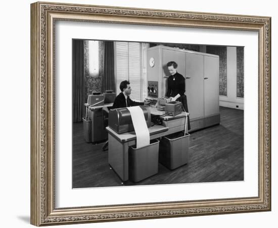 Man and a Women Working Together with a Pegasus Computer-null-Framed Photographic Print