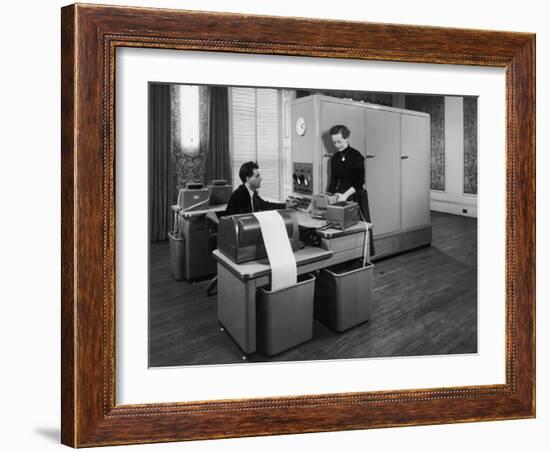 Man and a Women Working Together with a Pegasus Computer-null-Framed Photographic Print