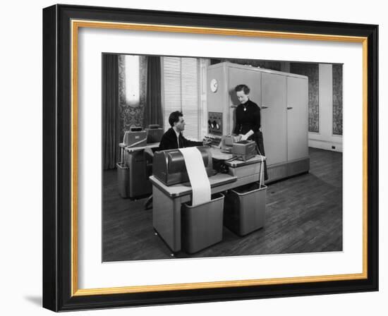 Man and a Women Working Together with a Pegasus Computer-null-Framed Photographic Print