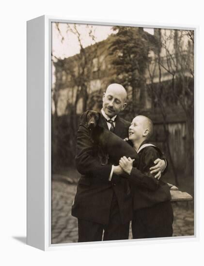 Man and Boy Holding a Dachshund-null-Framed Premier Image Canvas