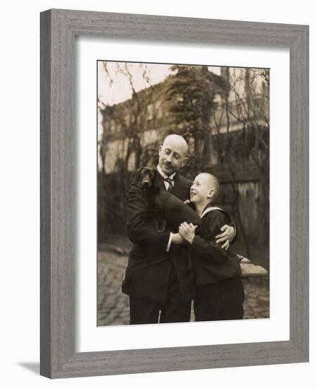 Man and Boy Holding a Dachshund-null-Framed Photographic Print