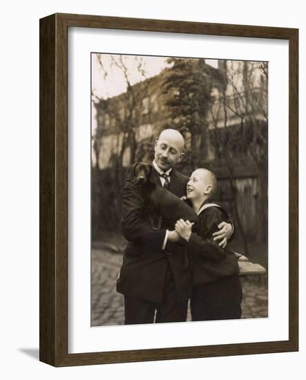 Man and Boy Holding a Dachshund-null-Framed Photographic Print