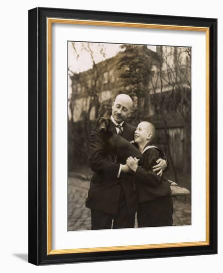 Man and Boy Holding a Dachshund-null-Framed Photographic Print