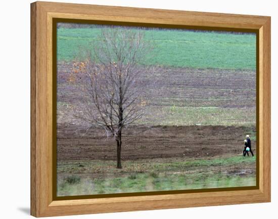 Man and Child Pass Through the Former Location of the Amish School in Nickel Mines, Pennsylvania-null-Framed Premier Image Canvas