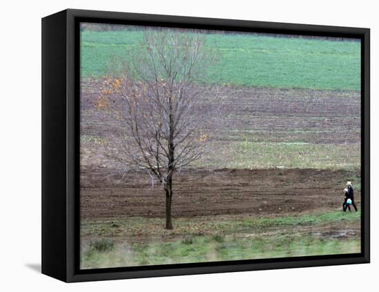 Man and Child Pass Through the Former Location of the Amish School in Nickel Mines, Pennsylvania-null-Framed Premier Image Canvas