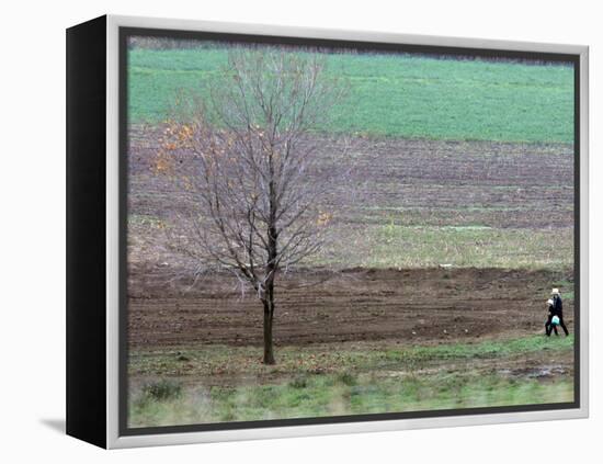 Man and Child Pass Through the Former Location of the Amish School in Nickel Mines, Pennsylvania-null-Framed Premier Image Canvas