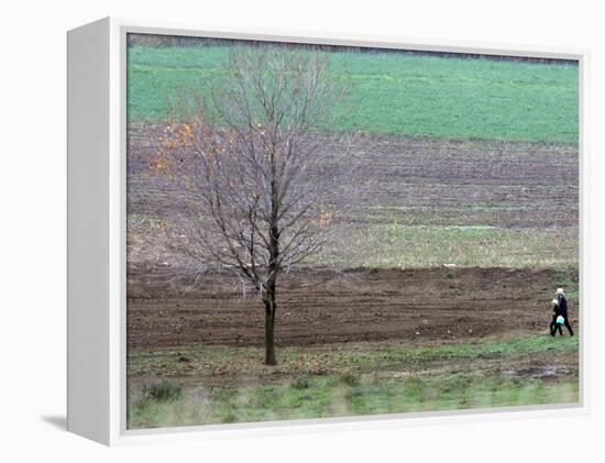 Man and Child Pass Through the Former Location of the Amish School in Nickel Mines, Pennsylvania-null-Framed Premier Image Canvas