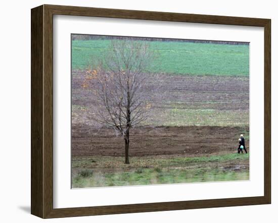 Man and Child Pass Through the Former Location of the Amish School in Nickel Mines, Pennsylvania-null-Framed Photographic Print