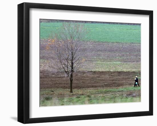 Man and Child Pass Through the Former Location of the Amish School in Nickel Mines, Pennsylvania-null-Framed Photographic Print