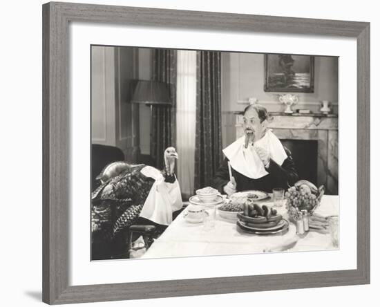 Man and His Pet Turkey Sitting Down to an Untraditonal Thanksgiving Dinner-null-Framed Photo