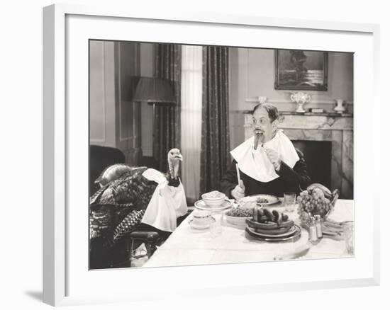 Man and His Pet Turkey Sitting Down to an Untraditonal Thanksgiving Dinner-null-Framed Photo