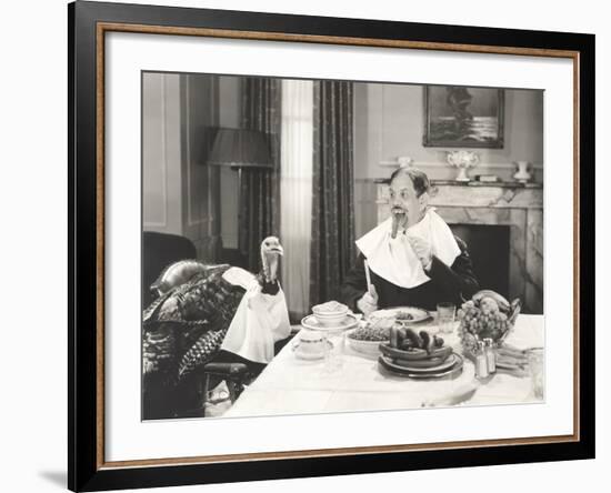 Man and His Pet Turkey Sitting Down to an Untraditonal Thanksgiving Dinner-null-Framed Photo