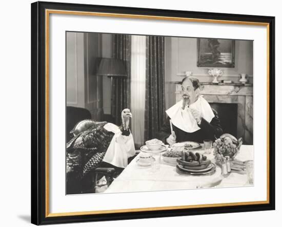 Man and His Pet Turkey Sitting Down to an Untraditonal Thanksgiving Dinner-null-Framed Photo