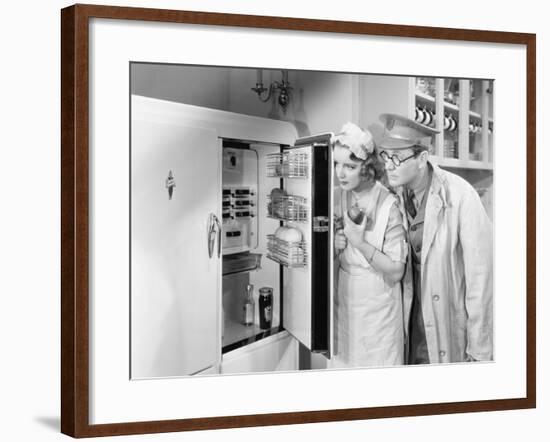 Man and Woman Standing in Front of a Refrigerator-null-Framed Photo