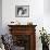 Man Bending over a Piece of Paper on His Dresser and Holding His Head-null-Framed Photo displayed on a wall