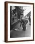 Man Bending over to Touch Cat Sitting on Sidewalk-Nina Leen-Framed Photographic Print
