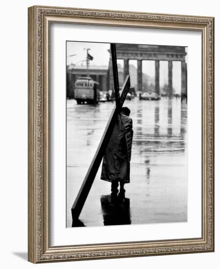 Man Carrying Cross, Berlin, October 1961-Toni Frissell-Framed Photo