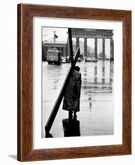 Man Carrying Cross, Berlin, October 1961-Toni Frissell-Framed Photo