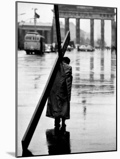 Man Carrying Cross, Berlin, October 1961-Toni Frissell-Mounted Photo