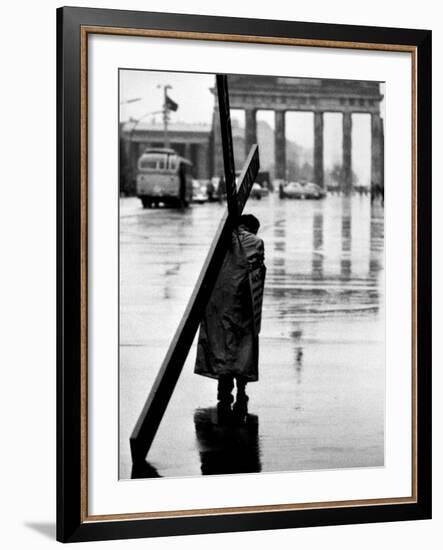 Man Carrying Cross, Berlin, October 1961-Toni Frissell-Framed Photo