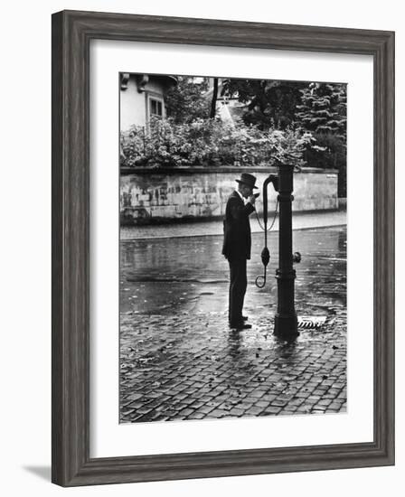 Man Drinking from Public Water Pump Fountain on Street, Frankfort-On-The-Main, Germany-Alfred Eisenstaedt-Framed Photographic Print