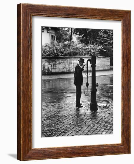 Man Drinking from Public Water Pump Fountain on Street, Frankfort-On-The-Main, Germany-Alfred Eisenstaedt-Framed Photographic Print