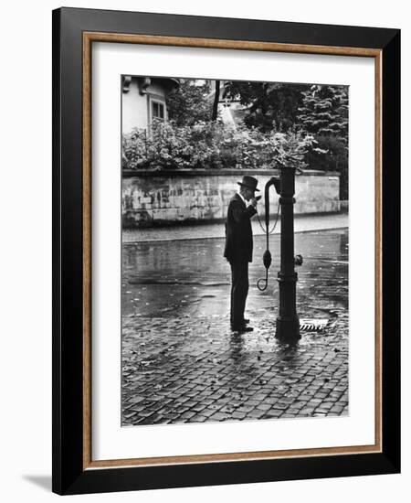 Man Drinking from Public Water Pump Fountain on Street, Frankfort-On-The-Main, Germany-Alfred Eisenstaedt-Framed Photographic Print