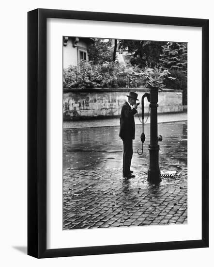 Man Drinking from Public Water Pump Fountain on Street, Frankfort-On-The-Main, Germany-Alfred Eisenstaedt-Framed Photographic Print
