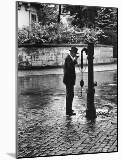 Man Drinking from Public Water Pump Fountain on Street, Frankfort-On-The-Main, Germany-Alfred Eisenstaedt-Mounted Photographic Print