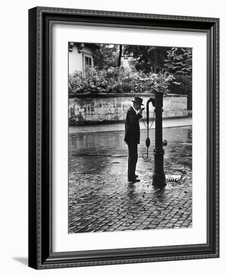 Man Drinking from Public Water Pump Fountain on Street, Frankfort-On-The-Main, Germany-Alfred Eisenstaedt-Framed Photographic Print