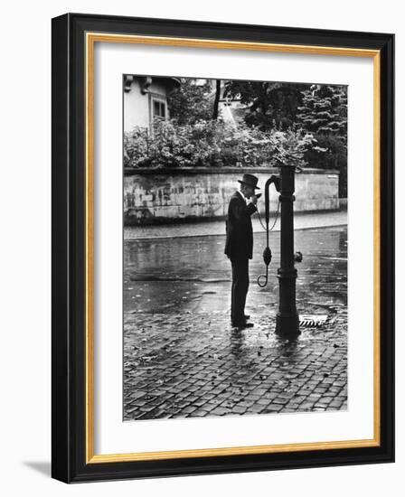 Man Drinking from Public Water Pump Fountain on Street, Frankfort-On-The-Main, Germany-Alfred Eisenstaedt-Framed Photographic Print