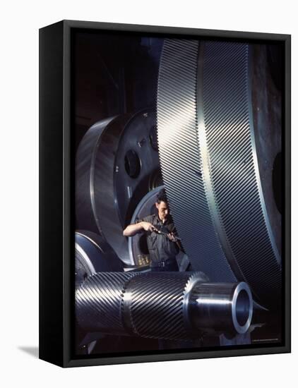 Man Dwarfed by Gigantic Gears He is Working on for the Navy, at General Electric Plant in US-Dmitri Kessel-Framed Premier Image Canvas