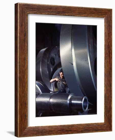 Man Dwarfed by Gigantic Gears He is Working on for the Navy, at General Electric Plant in US-Dmitri Kessel-Framed Photographic Print