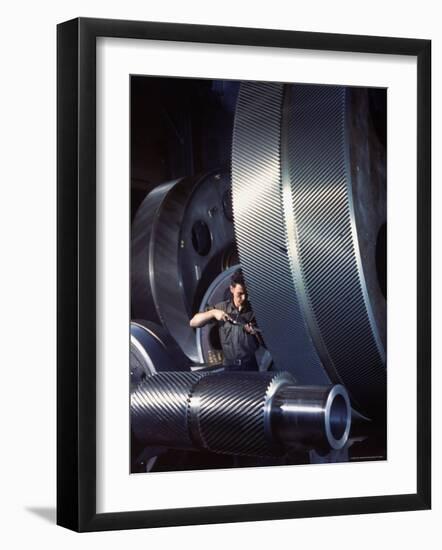 Man Dwarfed by Gigantic Gears He is Working on for the Navy, at General Electric Plant in US-Dmitri Kessel-Framed Photographic Print