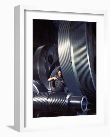 Man Dwarfed by Gigantic Gears He is Working on for the Navy, at General Electric Plant in US-Dmitri Kessel-Framed Photographic Print