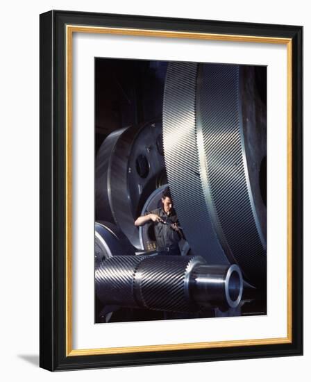 Man Dwarfed by Gigantic Gears He is Working on for the Navy, at General Electric Plant in US-Dmitri Kessel-Framed Photographic Print