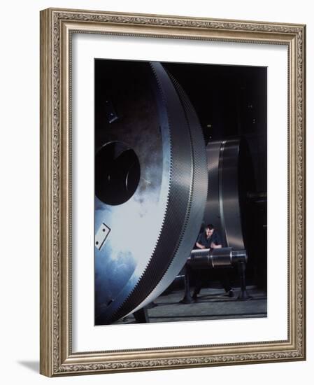 Man Dwarfed by Gigantic Gears He is Working on for the Navy, at General Electric Plant in US-Dmitri Kessel-Framed Photographic Print