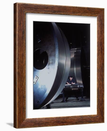 Man Dwarfed by Gigantic Gears He is Working on for the Navy, at General Electric Plant in US-Dmitri Kessel-Framed Photographic Print