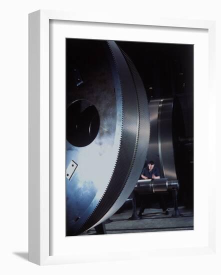 Man Dwarfed by Gigantic Gears He is Working on for the Navy, at General Electric Plant in US-Dmitri Kessel-Framed Photographic Print