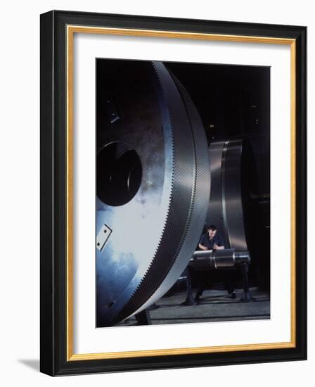 Man Dwarfed by Gigantic Gears He is Working on for the Navy, at General Electric Plant in US-Dmitri Kessel-Framed Photographic Print