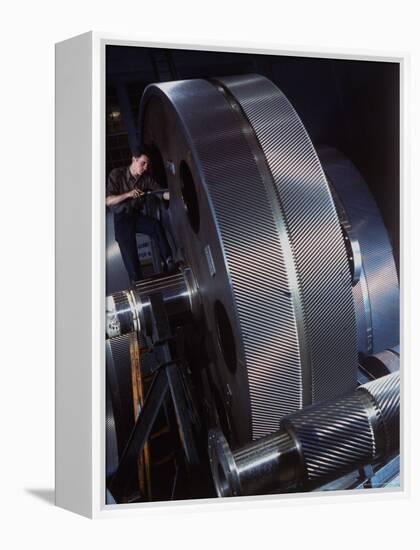 Man Dwarfed by Gigantic Gears He is Working on for the Navy, at General Electric Plant in US-Dmitri Kessel-Framed Premier Image Canvas