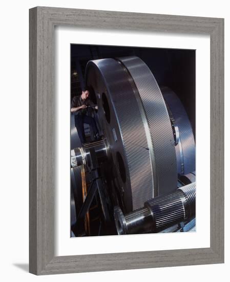 Man Dwarfed by Gigantic Gears He is Working on for the Navy, at General Electric Plant in US-Dmitri Kessel-Framed Photographic Print